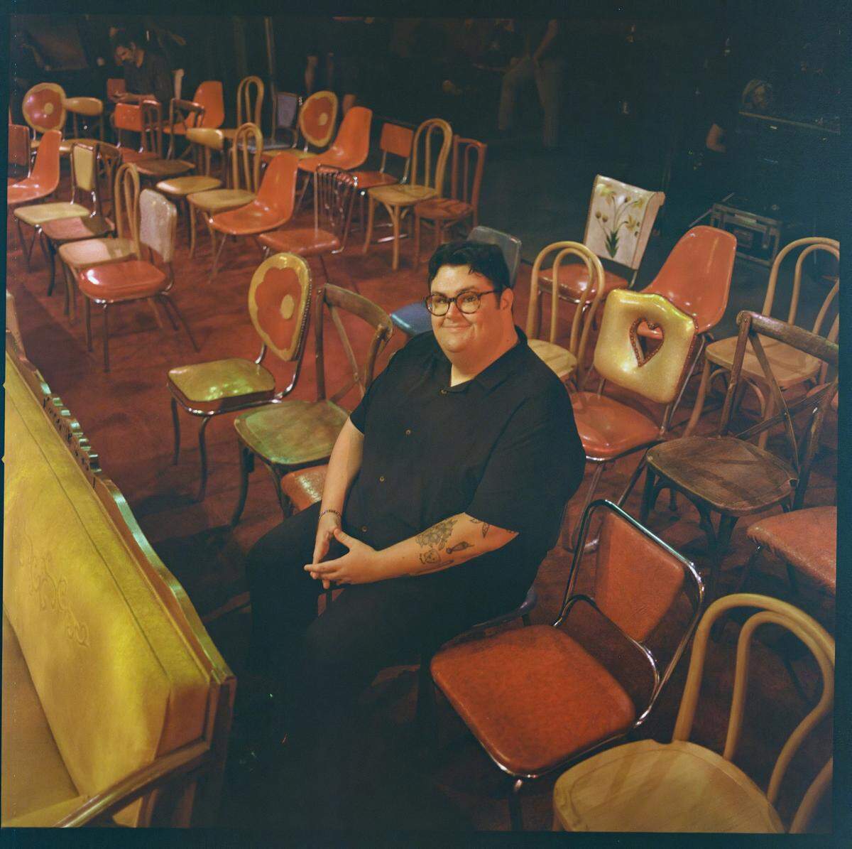 Caleb Hearon sits inside Constellation, a performing arts nightclub in Chicago. It’s where they filmed his hour-long HBO Max special, “Caleb Hearon: Model Comedian,” debuting Friday, Sept. 19.