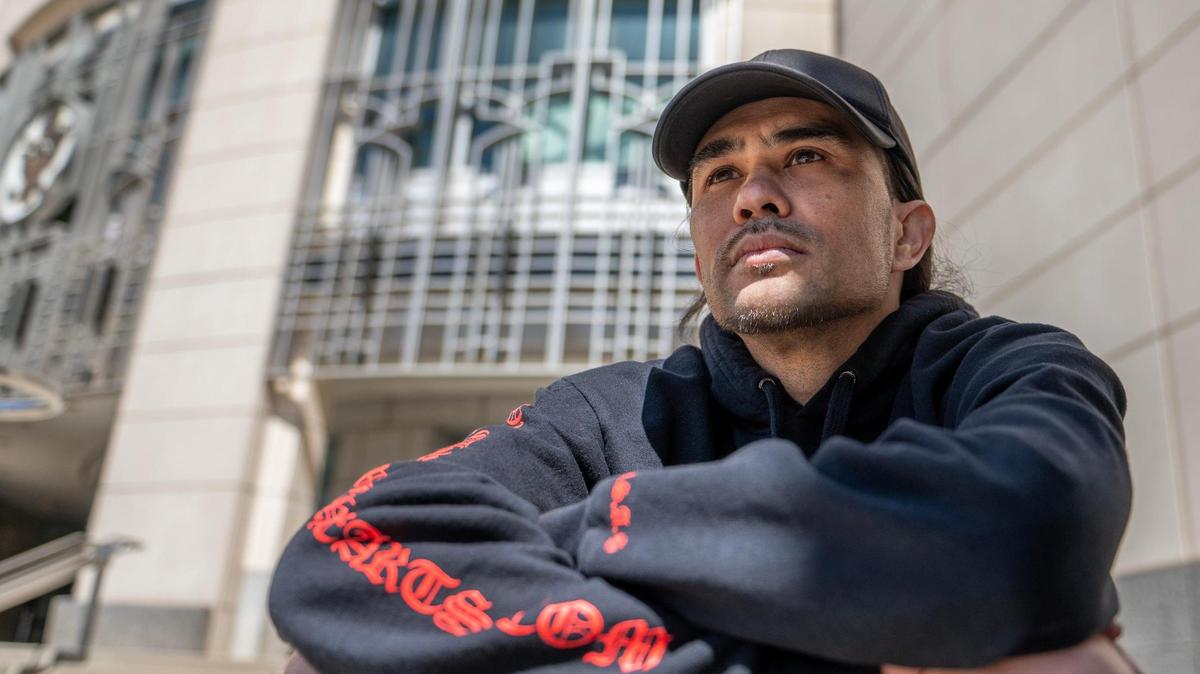 Sean Null sits on the steps of the Charles Evans Whittaker U.S. Courthouse in Kansas City on April 7. Null filed a federal lawsuit against members of the Kansas City Police Department and the Jackson County Prosecutor’s Office.