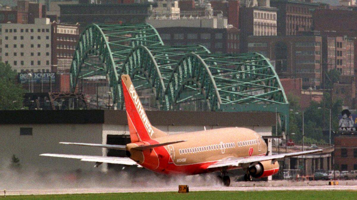 The downtown Kansas City skyline and the Buck O’Neil Bridge served as a background as a Southwest Airlines jet makes an unexpected landing at the downtown airport during a rainstorm in 1998.