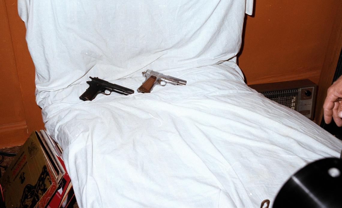 As they searched the crime scene, evidence technicians collected dozens of items, including two handguns.