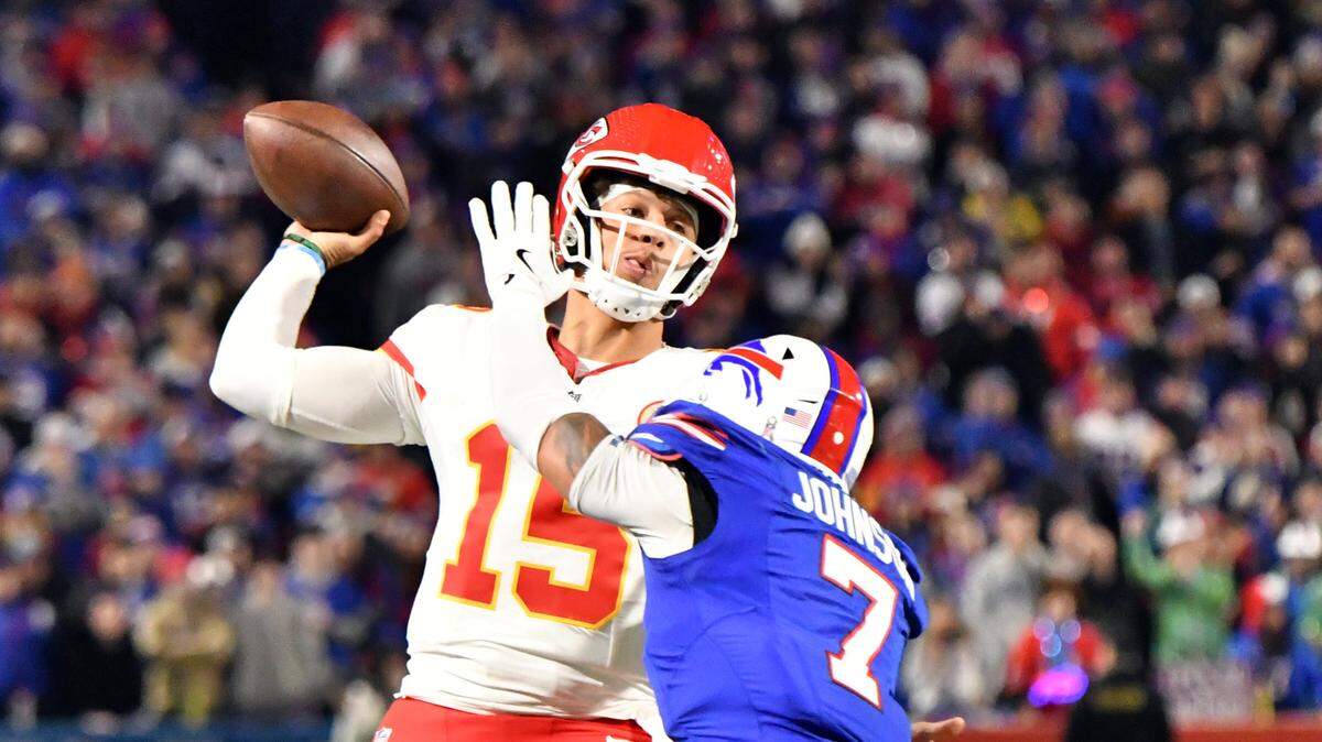 Kansas City Chiefs quarterback Patrick Mahomes (15) is pressured by Buffalo Bills cornerback Taron Johnson (7) as he releases a pass in the second quarter at Highmark Stadium.