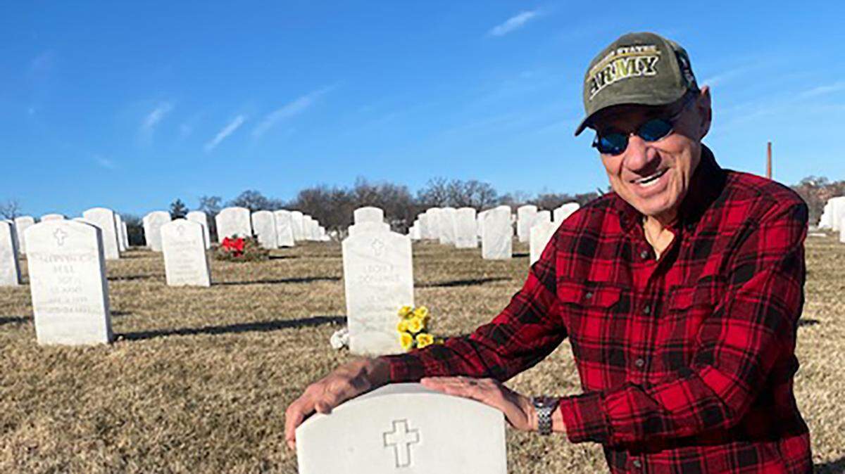 Michael Lee Kobe, at the grave of his World War II veteran father John Kobe at the military cemetery in Leavenworth.