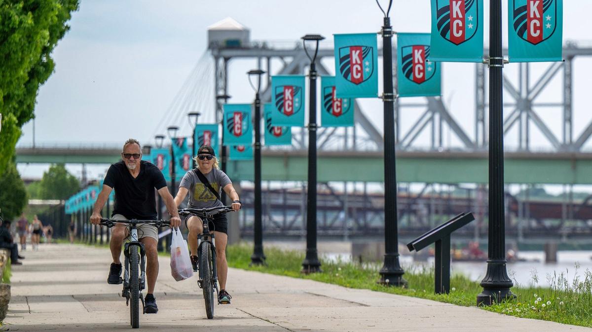 Cyclists ride along the Berkley Riverfront. The trail will be extended to the West Bottoms.