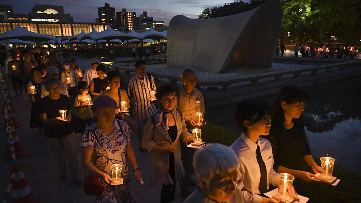 People march with candles at Peace Memorial Park in Hiroshima on the night of July 31, 2023, at an event to mourn atomic bomb victims ahead of the 78th anniversary on Aug. 6 of the world’s first atomic bombing by the United States on the western Japan city during World War II. (Photo by Kyodo News/Sipa USA)