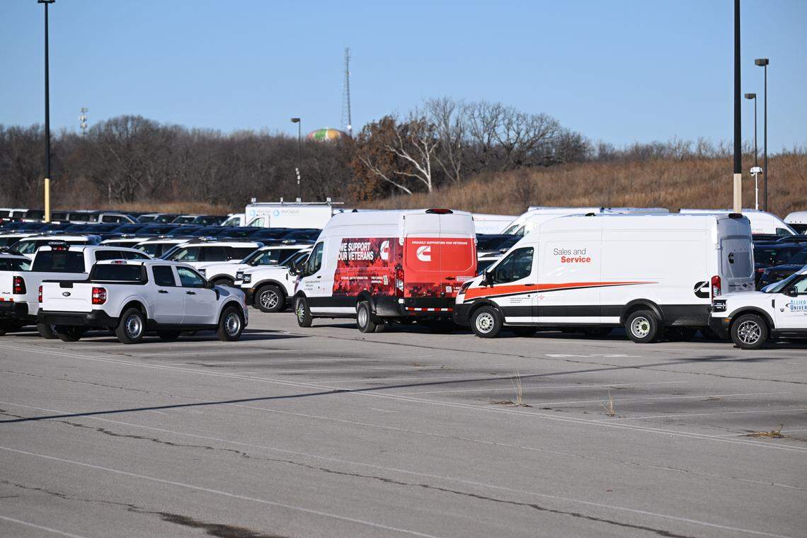 ICE vehicles are blocked by vans and security vehicles in a lot near Worlds of Fun in Kansas City on Wednesday, January 14, 2026.