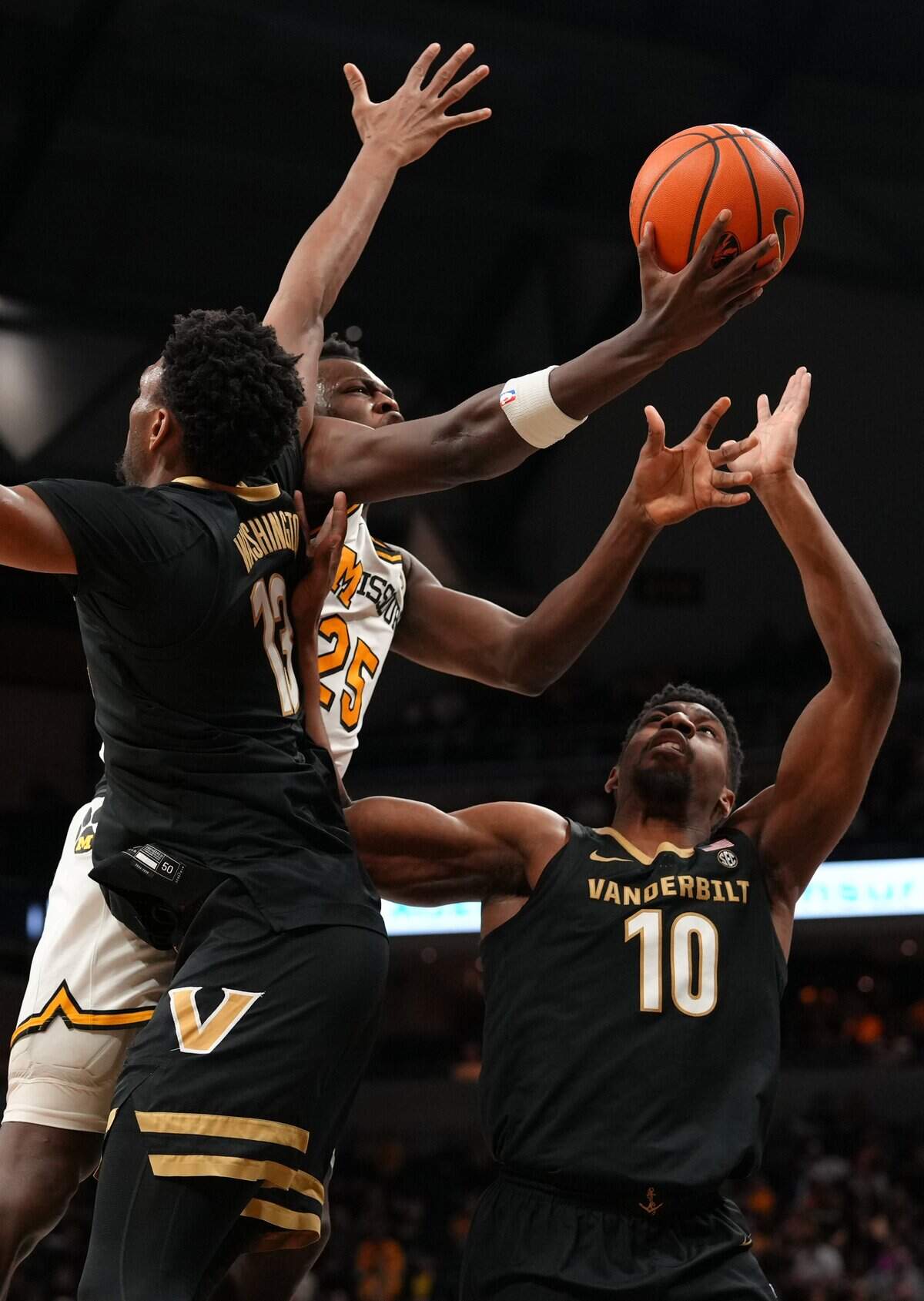 Missouri Tigers forward Mark Mitchell splits Vanderbilt defenders Jalen Washington and Ak Okereke for a layup during an SEC men’s basketball game at Mizzou Arena in Columbia on Wednesday, Feb. 18, 2026.