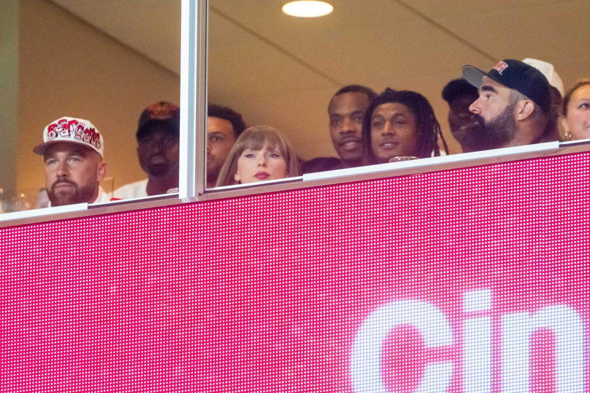 Travis Kelce, Taylor Swift and Jason Kelce watch during the second quarter between the Cincinnati Bearcats and the Nebraska Cornhuskers at GEHA Field at Arrowhead Stadium.