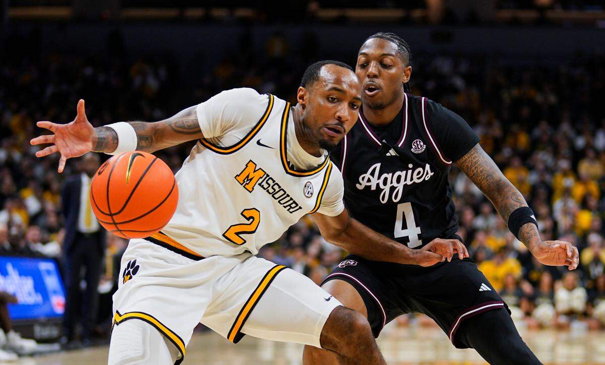Missouri Tigers guard Tamar Bates (No. 2) tries to corral the basketball against Texas A&M Aggies guard Wade Taylor IV during an SEC game at Mizzou Arena in Columbia on Saturday, Feb. 8, 2025.