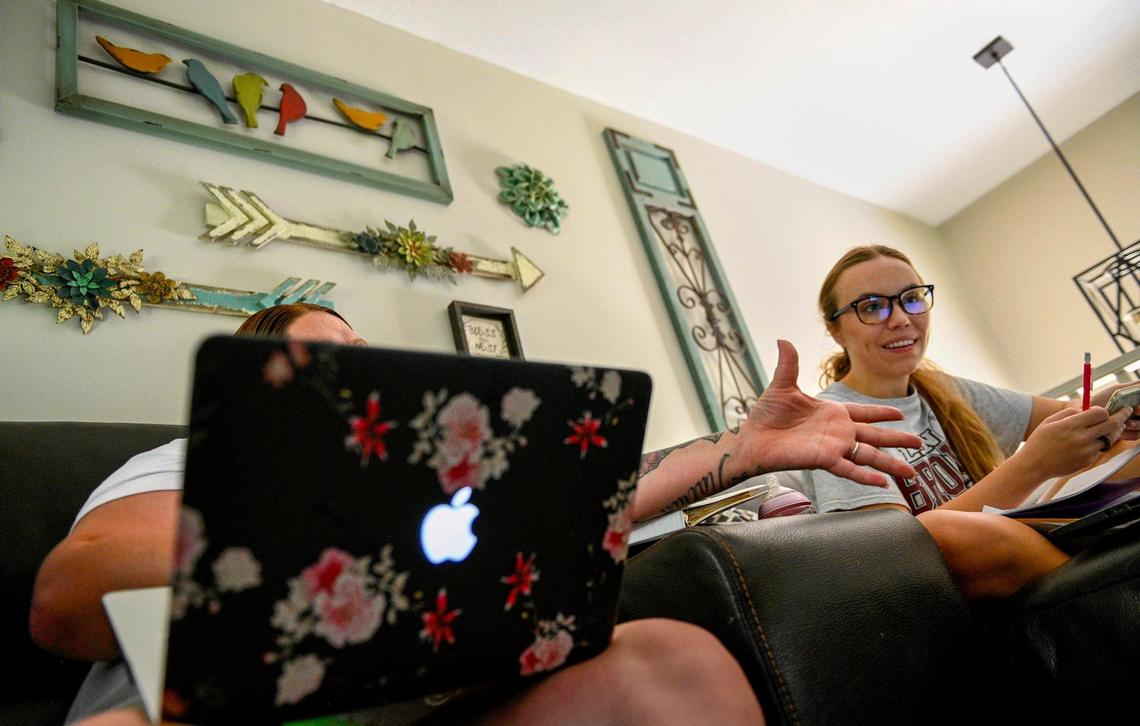 A woman at Restoration House of Greater Kansas City in Harrisonville goes over math homework with volunteer tutor Kari Gage Tuesday, July 27, 2021. The woman credits Gage with helping her get her diploma, although she has one more class to finish up. After 10 years of being trafficked for sex the woman escaped by calling a hotline. The 33-year-old survivor is rebuilding her life at Restoration House in Harrisonville where she lives with other survivors. She wants to help other women who experienced being trafficked.