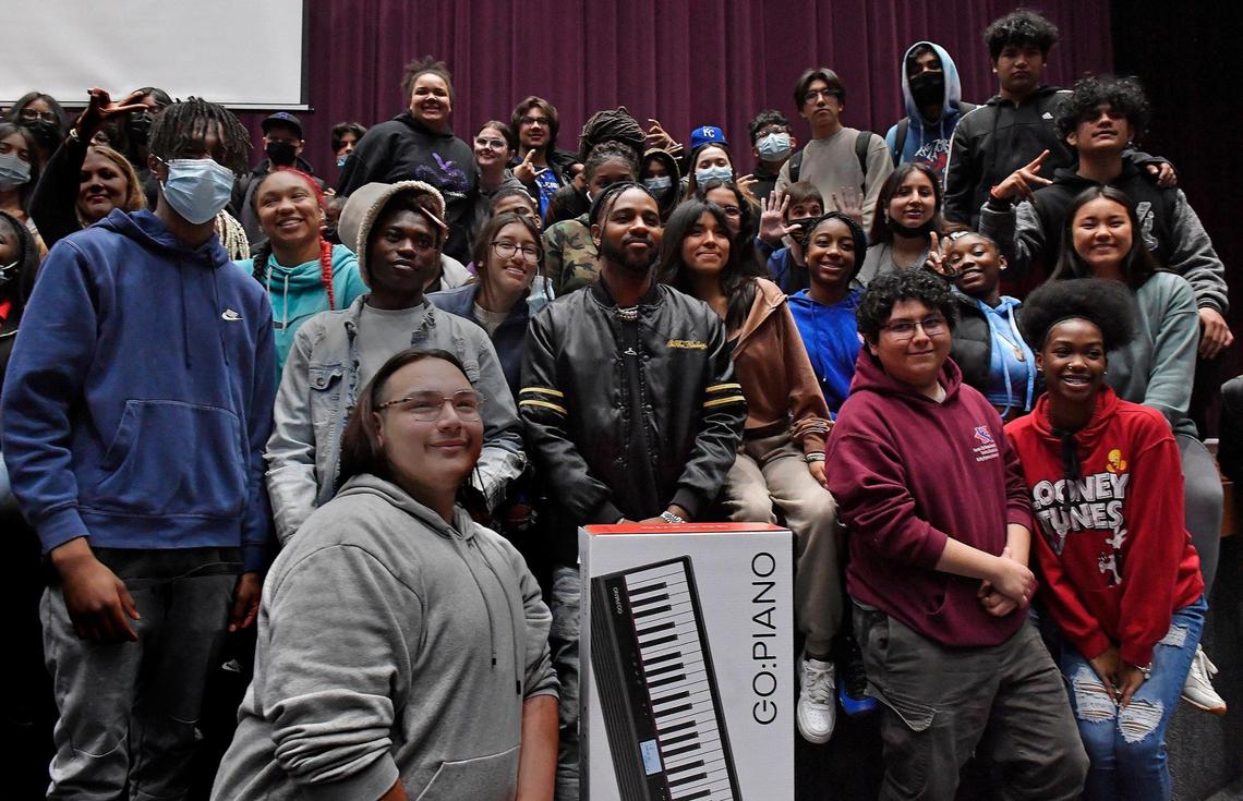 Bernard Harvey, middle, who is the musical director for Justin Bieber, stopped by J.C. Harmon High School in Kansas City, Kansas Tuesday, to meet with about 150 music students at his alma mater. Harvey, who grew up in KCK, surprised the students with a donation of instruments for the school.