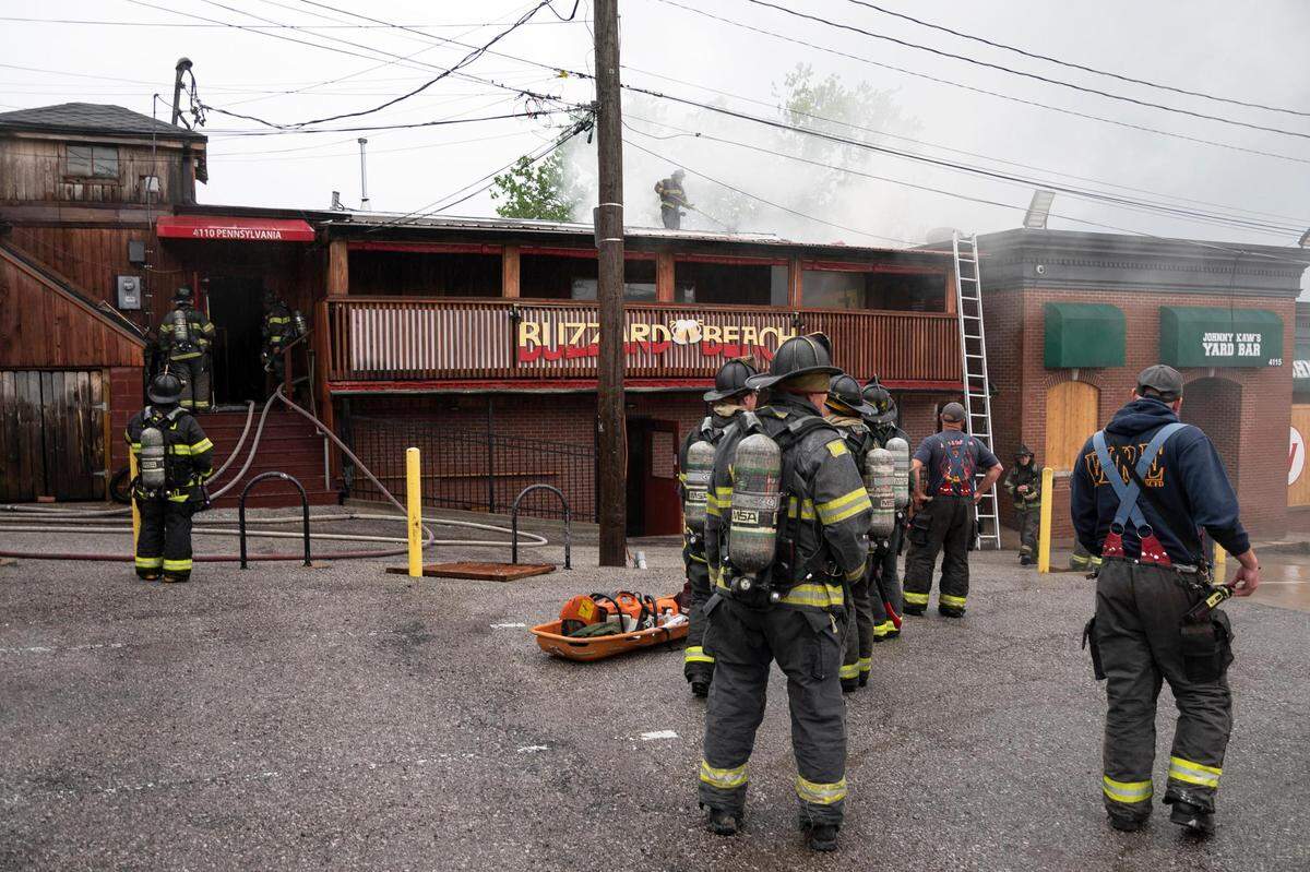 Firefighters work to fully extinguish a fire that broke out late in the morning at the Buzzard Beach bar in Kansas City on May 31, 2022.