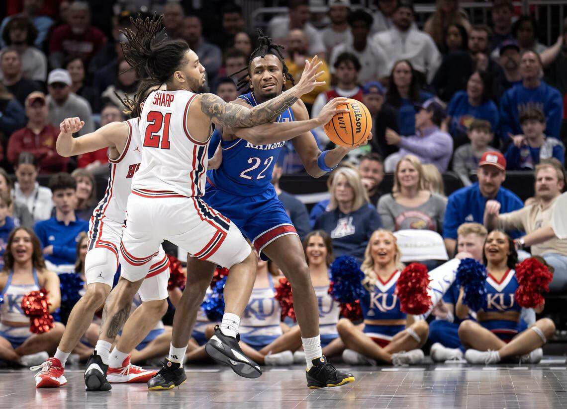 Kansas Jayhawks guard Darryn Peterson (22) handles the ball as Houston Cougars guard Emanuel Sharp (21) defends in the second half at the Big 12 Men's Basketball Tournament at T-Mobile Center on Friday, March 13, 2026, in Kansas City. Houston defeated Kansas, 69-47.