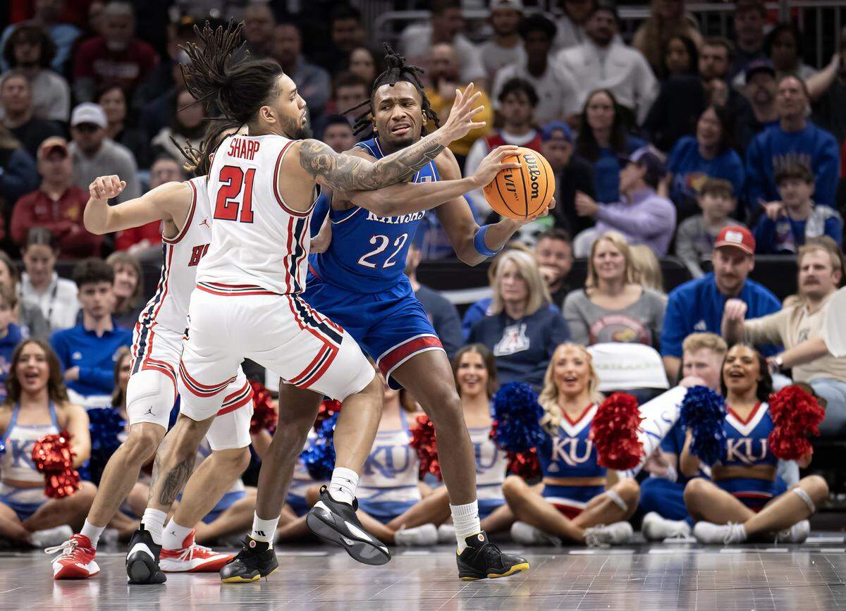 Kansas Jayhawks guard Darryn Peterson (22) handles the ball as Houston Cougars guard Emanuel Sharp (21) defends in the second half at the Big 12 Men's Basketball Tournament at T-Mobile Center on Friday, March 13, 2026, in Kansas City. Houston defeated Kansas, 69-47.