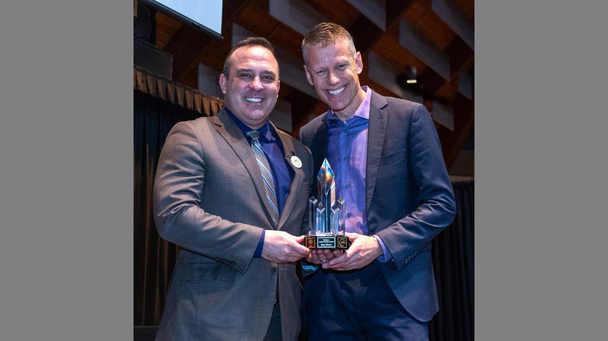 Dan Meers, otherwise known as KC Wolf, accepts the Lee’s Summit CARES Lifetime Achievement Award at the 2020 Mayor’s Character last week from Mayor Bill Baird.