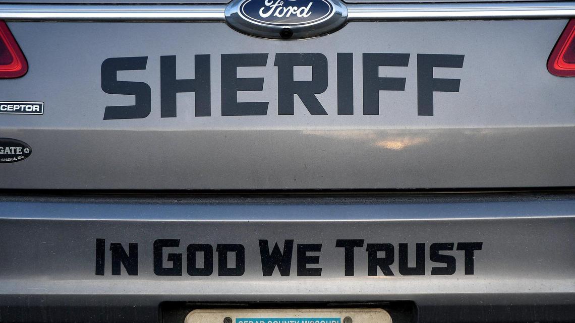 A Cedar County, Missouri, sheriff’s vehicle bears the message “In God we trust.” The Star has found close ties between Agape and law enforcement in Cedar County.