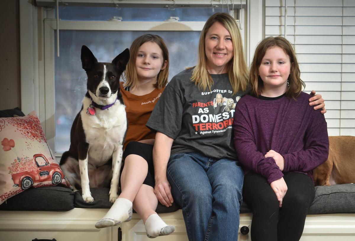 Christine Kraft at home with with her daughters, Caydence, 11, left, and Corra Kraft, 9. Christine Kraft is a member of the Northland Parent Association, an organization whose website describes it as a group of grassroots fighters “for American freedom in the classroom.”