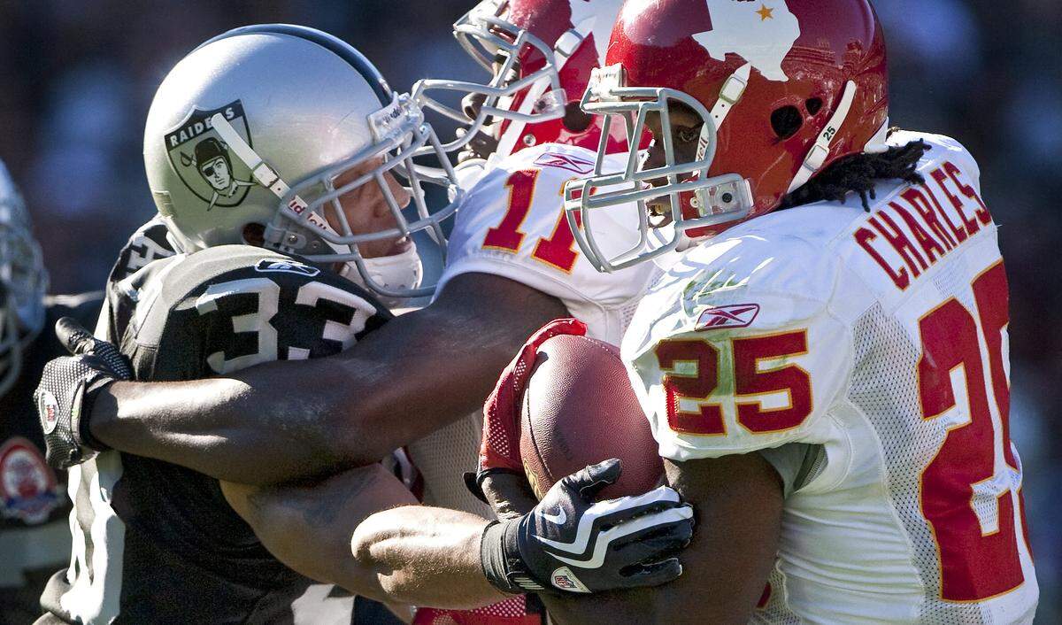 Kansas City Chiefs running back Jamaal Charles (25) breaks free from the reach of Oakland Raiders cornerback Tyvon Branch (33) and scores a touchdown with 12:25 remaining in the second quarter during Sunday’s November 15, 2009 football game between the Kansas City Chiefs and Oakland Raiders at Oakland-Alameda County Coliseum in Oakland, CA. John Sleezer/The Kansas City Star