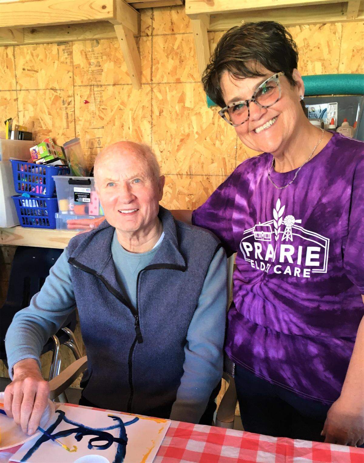 Lisa Elliott admires the artwork created by Matt Buchman during a workshop in the barn. Elliott is the director of engagement for Prairie Elder Care.