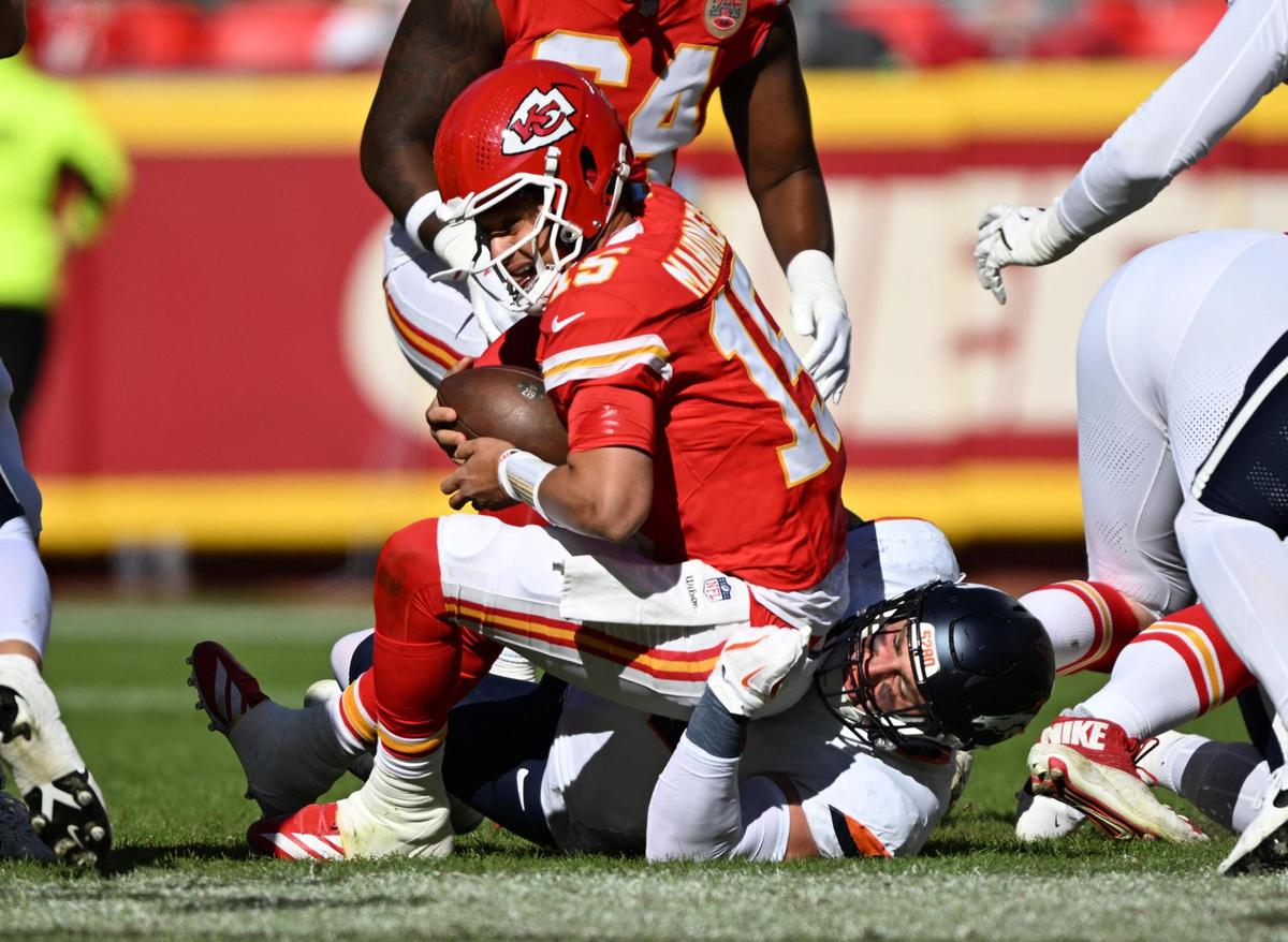 Kansas City Chiefs quarterback Patrick Mahomes (15) is sacked by Denver Broncos defensive end Zach Allen (99) in the first quarter on Sunday, Nov. 10, 2024, at GEHA Field at Arrowhead Stadium.
