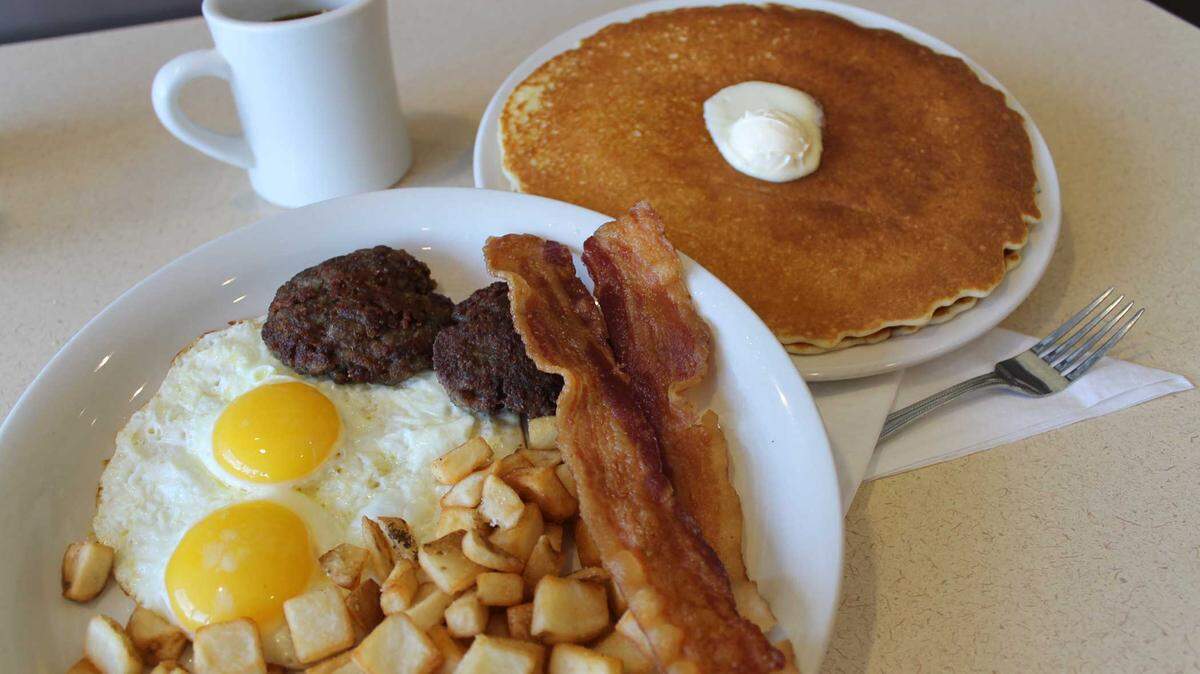 Big Biscuit’s Big Breakfast with two eggs, two slices of bacon, two sausages, potatoes, and a choice of a biscuit and gravy or two pancakes.