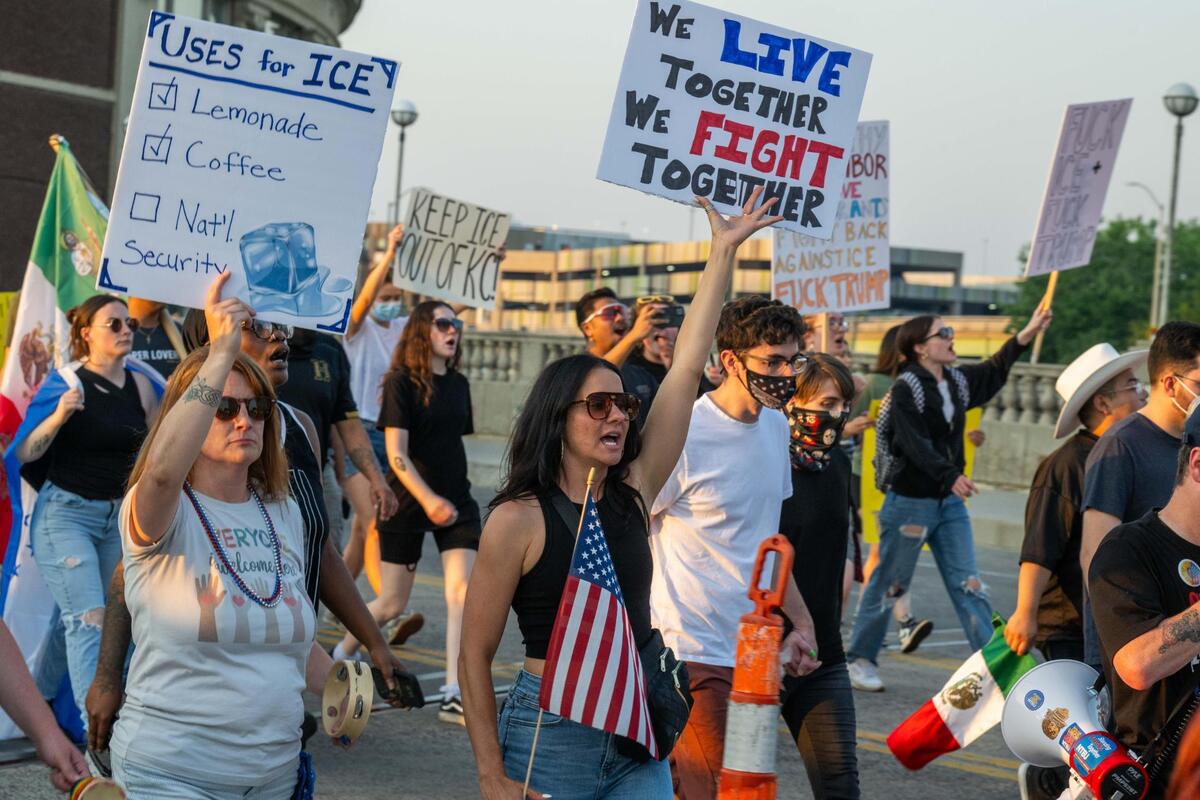 Several hundred people march through downtown towards the Liberty Memorial during a “Shut Down ICE” protest on Kansas City’s Westside and downtown areas on Tuesday, June 10, 2025. People held signs and flags and chanted in support of immigrants and against the Trump administration’s immigration policies.