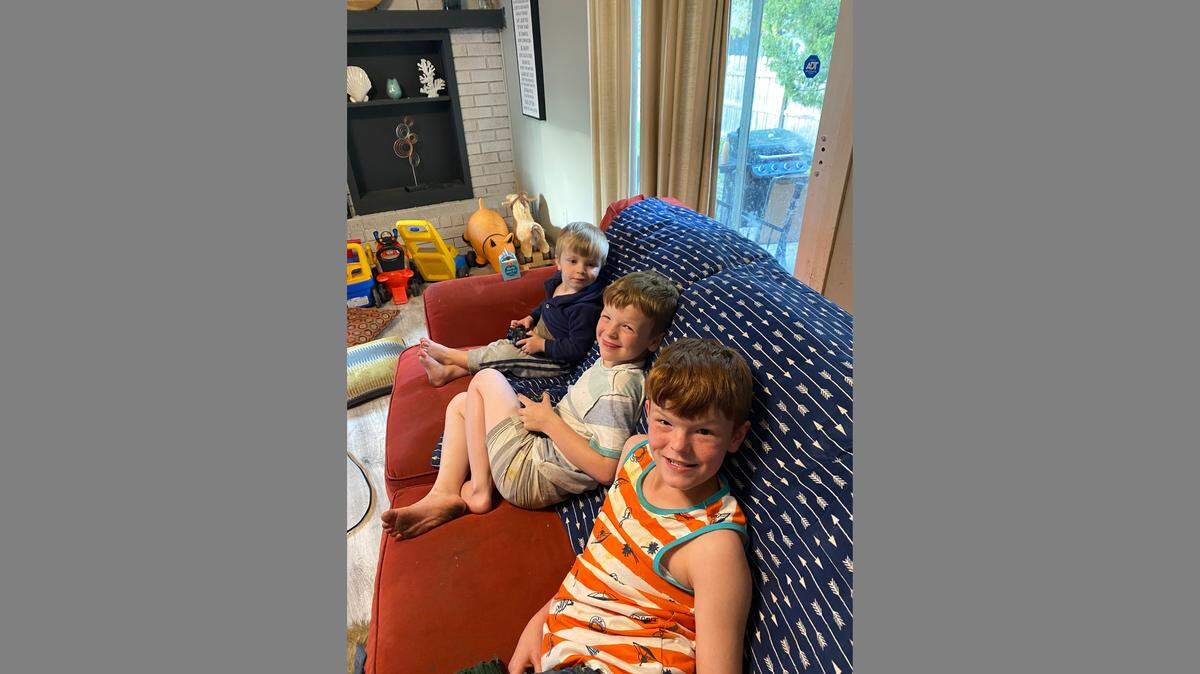 Jude, Bentley, Skylar relax on the couch at their foster family’s home.