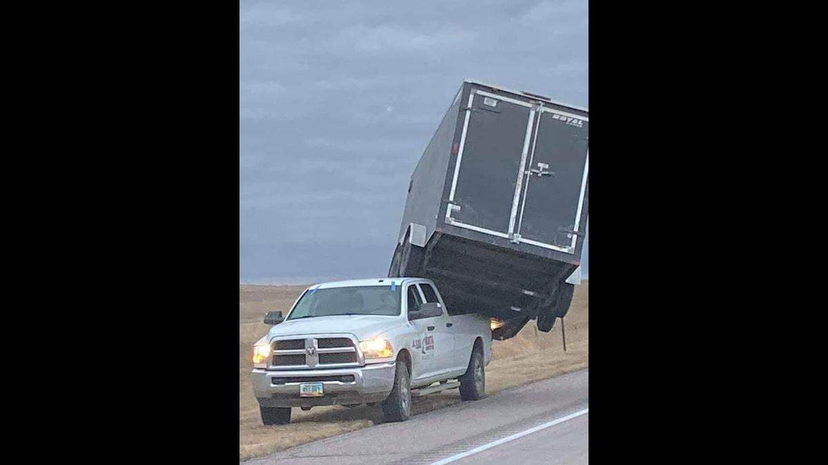 Officials in Nebraska say high winds blew a trailer into the bed of the truck that was pulling it.