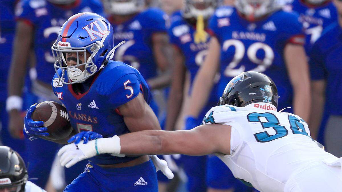 Kansas wide receiver Stephon Robinson Jr. (5) breaks away from Coastal Carolina linebacker Teddy Gallagher (34) during the first half of a college football game in Lawrence, Kan., Saturday, Sept. 7, 2019.
