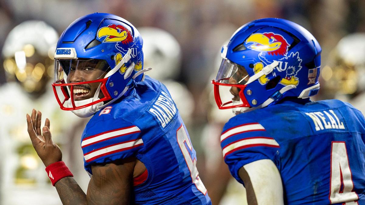 Kansas Jayhawks quarterback Jalon Daniels (6) and running back Devin Neal (4) celebrate late in the second half after Neal scored his fourth touchdown of the game at GEHA Field at Arrowhead Stadium on Saturday, Nov. 23, 2024, in Kansas City.