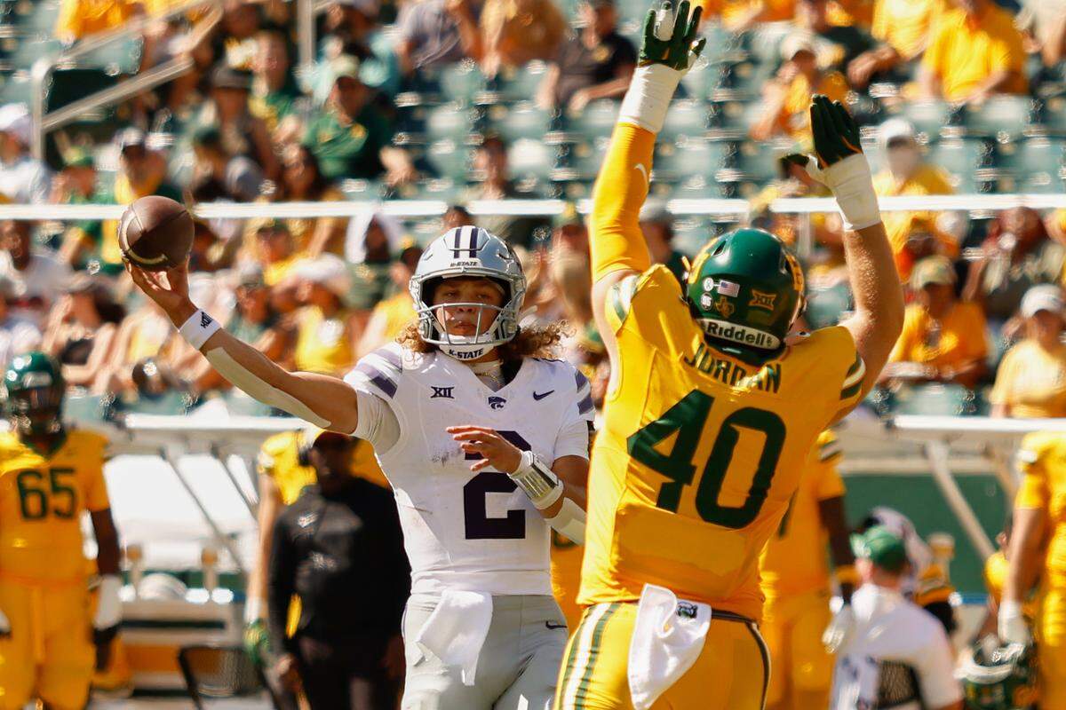 Kansas State Wildcats quarterback Avery Johnson (2) throws a pass against Baylor Bears linebacker Kyler Jordan (40) during the first half at McLane Stadium on Oct. 4, 2025.