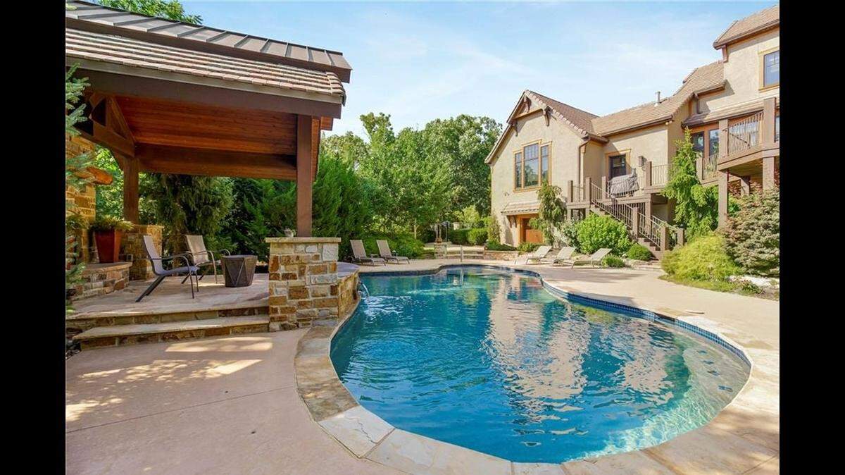 The house, 27409 W. 108th St. in Olathe, has an outdoor pool, hot tub and covered patio with heated flooring.