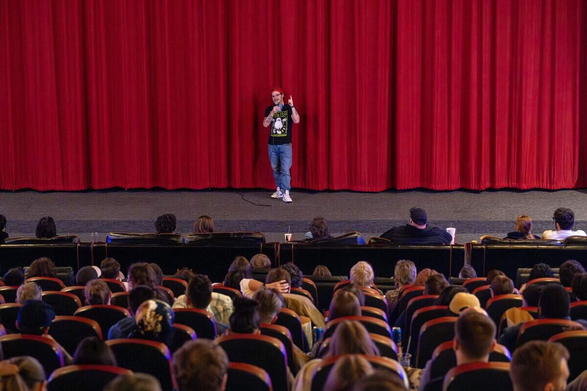 Adam Roberts, owner and operator of Screenland Armour Theatre, addresses the audience before a 70mm screening of “Sinners” on Friday, March 27, 2026, in North Kansas City.