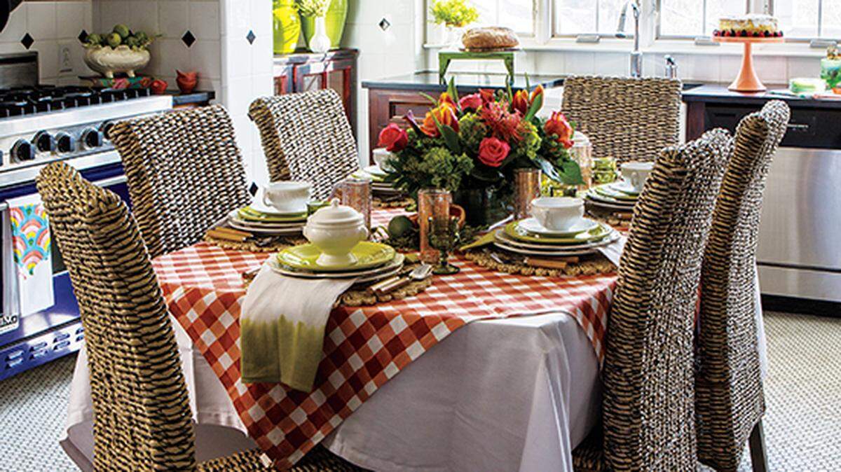 Set a springy scene by layering your table with two tablecloths. Then add stacks of bright white dishes, a pop or two of color and a beautiful floral centerpiece. Woven chairs add the perfect texture — and are always easy to clean. The tableware is from Pryde’s Kitchen & Necessities and Nell Hill’s. The chairs are from The Painted Sofa. Flowers by Trapp and Company.