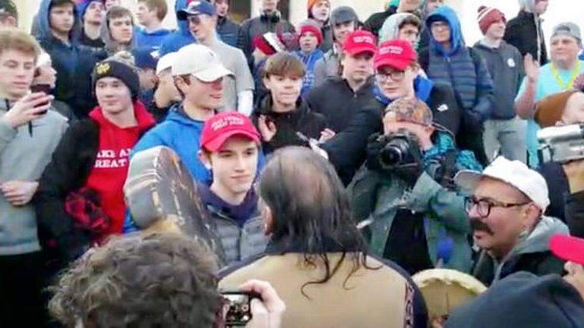 Covington Catholic High School student Nick Sandmann, bottom center, stands in front of Native American demonstrator Nathan Phillips at the Lincoln Memorial.