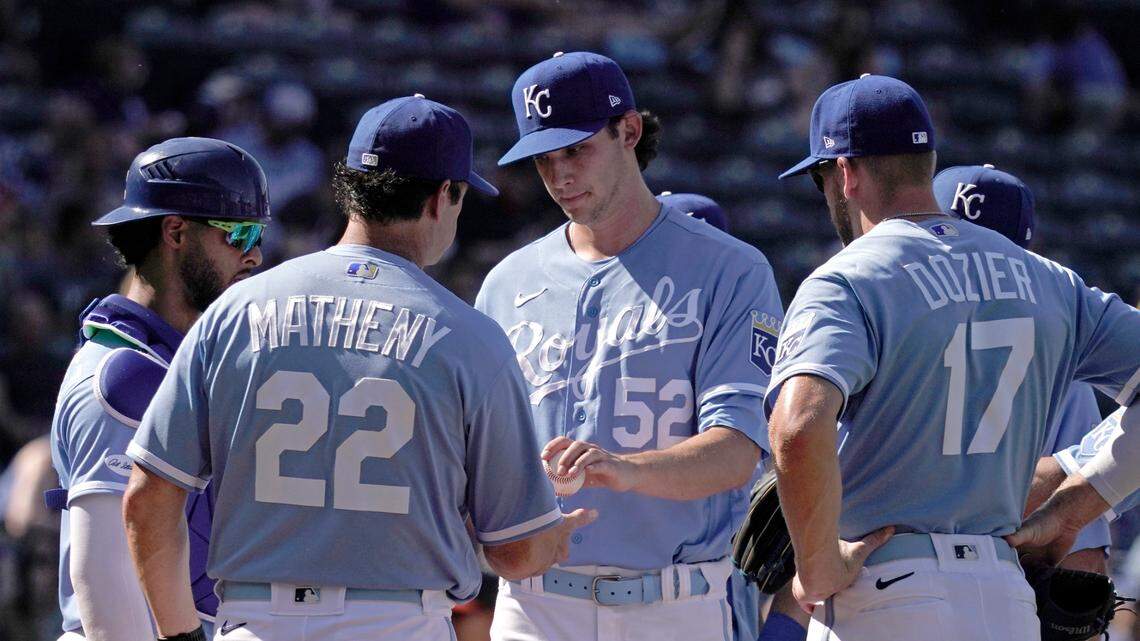 Kansas City Royals manager Mike Matheny (22) takes the ball from starting pitcher Daniel Lynch (52) as he makes a pitching change during the sixth inning of a baseball game against the Baltimore Orioles Saturday, June 11, 2022, in Kansas City, Mo. (AP Photo/Charlie Riedel)