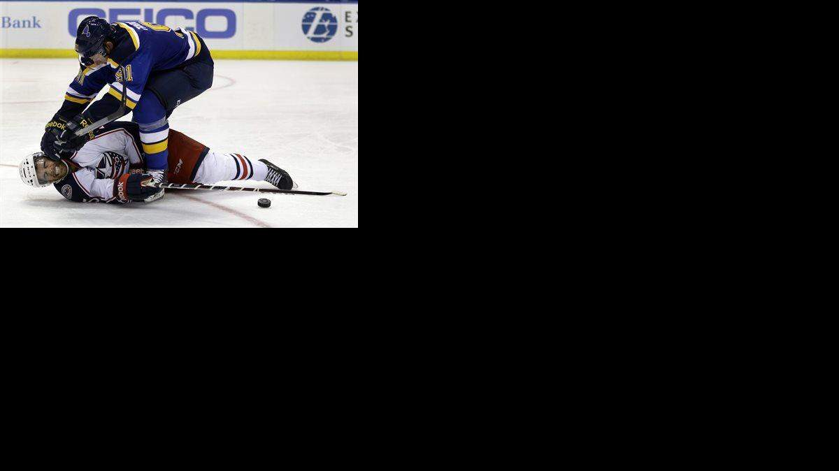 Columbus Blue Jackets' Jerry D'Amigo, bottom, is knocked to the ice by St. Louis Blues right wing Vladimir Tarasenko, of Russia, during the second period of a preseason NHL hockey game Thursday, Sept. 25, 2014, in St. Louis.