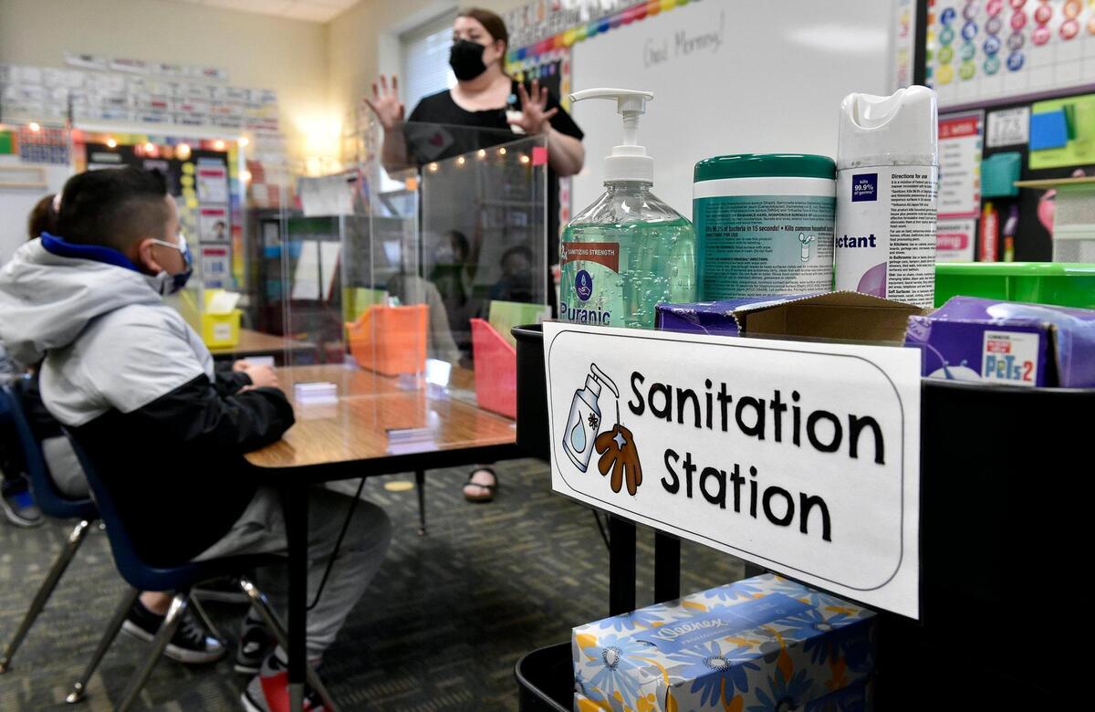 Reminders of the coronavirus were all around the school, including a sanitation station and desk partitions in Marion Heck’s first grade class. Students arrived at Douglass Elementary School in Kansas City, Kansas, Wednesday, March 31, 2021, for the first day of full in-person learning. According to Principal Louis Neal, about 75 percent of students are coming back for in-person learning.