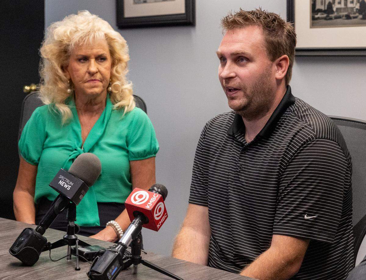 Luke Scheidecker, brother of John Paul Scheidecker, speaks at a press conference at the Clay County Sheriff’s Office on Tuesday, July 30, the one-year anniversary of John Paul’s death, as Elaine Scheidecker, his mother, looks on.