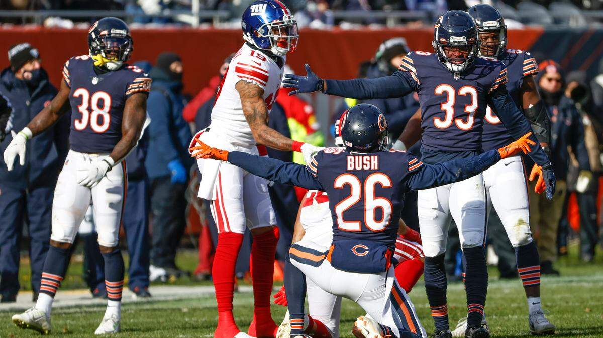 Chicago Bears safety Deon Bush (26) celebrates with cornerback Jaylon Johnson (33) a defensive stop against the New York Giants during the first half of an NFL football game, Sunday, Jan. 2, 2022, in Chicago. (AP Photo/Kamil Krzaczynski)