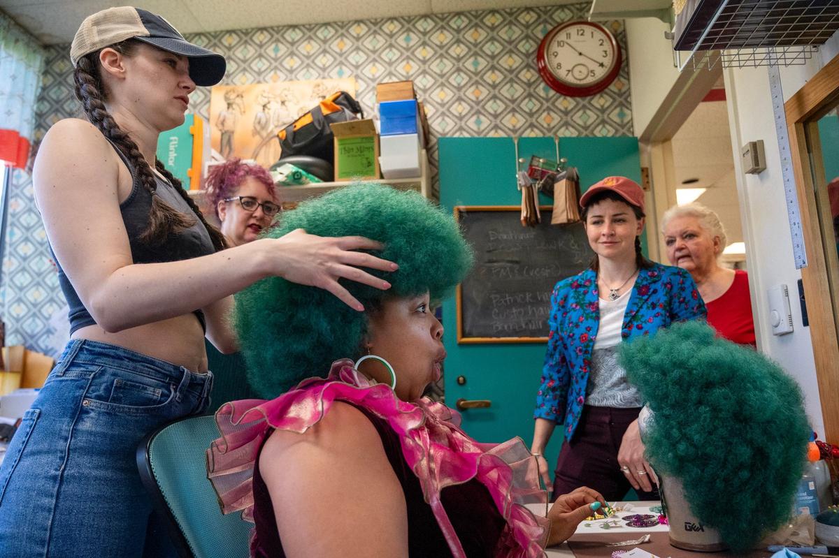 In the fitting room back stage, Mary Williams, left, adjusts the wig on Shon Ruffin, who is cast as Audrey II, in the Kansas City Repertory Theatre’s production of “Little Shop of Horrors.” The fitting on April 17, included Jana Jessee, a fitter/draper, second from left, costume designer Scully Ratke and Gayla Voss, hair and wig co-designer.