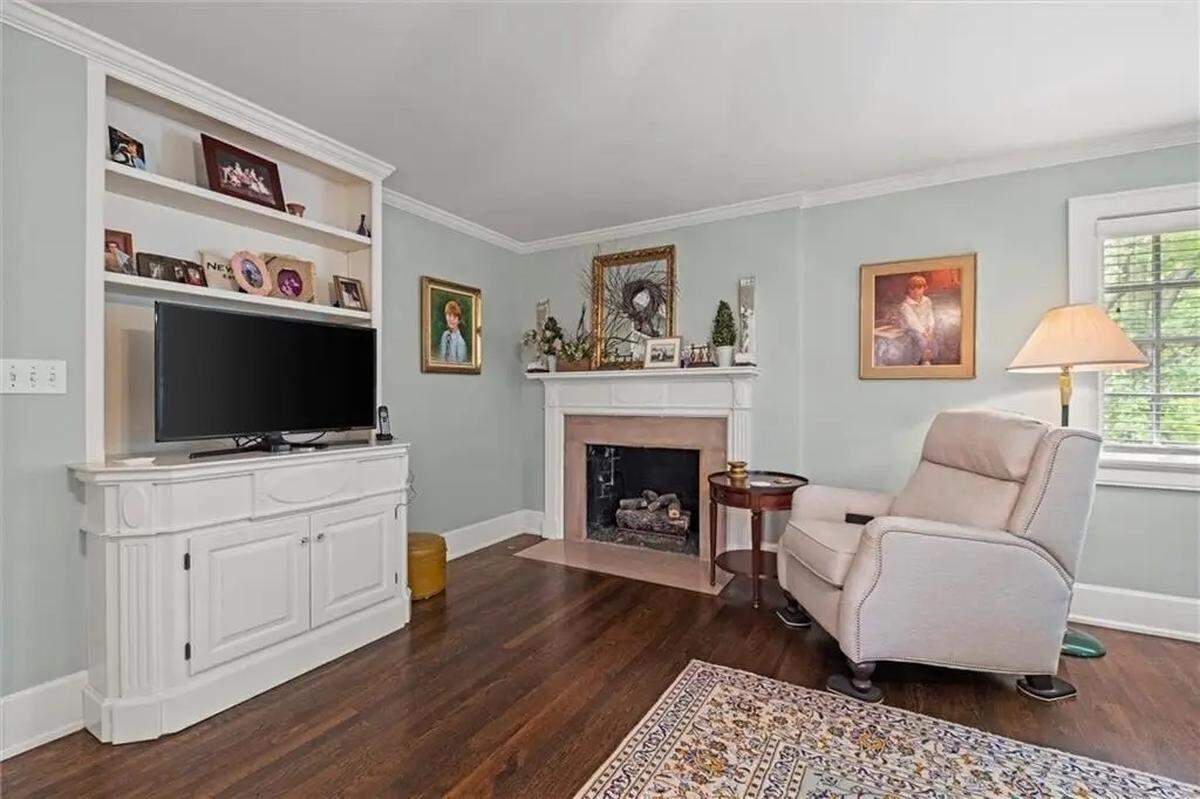 The main bedroom contains one of three fireplaces at 1234 W. 58th St. The century-old house is located in Kansas City near Ward Parkway and Mission Hills.