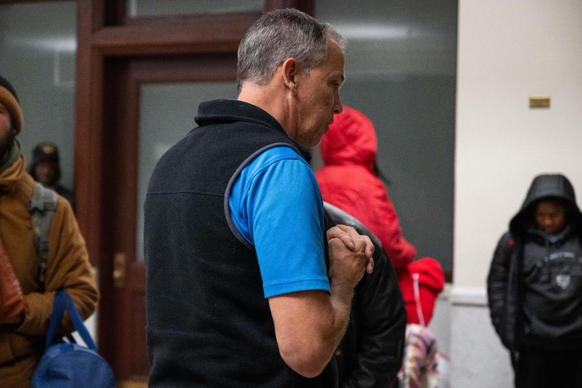 John Krause, director of Morning Glory Ministries, leads a prayer before the start of the morning breakfast program on Tuesday morning in downtown Kansas City.