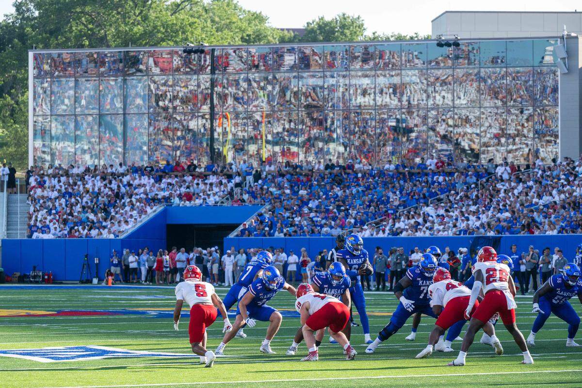 The Kansas Jayhawks offense lines up for a play in front of a newly designed players area inside David Booth Kansas Memorial Stadium prior to the Jayhawks game vs. the Fresno State Bulldogs on Saturday, Aug. 23, 2025, in Kansas City.