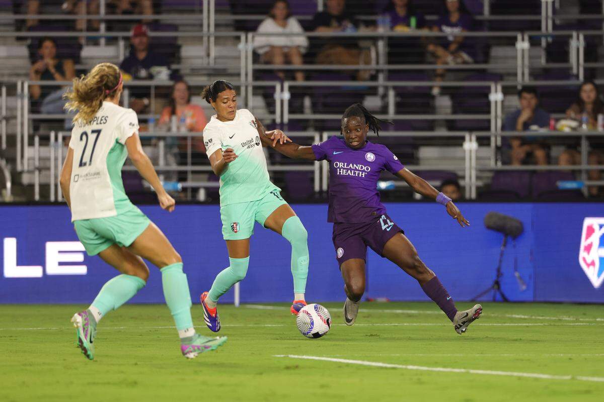 Orlando Pride forward Barbra Banda, right, battles Kansas City Current defender Alana Cook for possession during Friday evening’s NWSL match at Inter&Co Stadium.