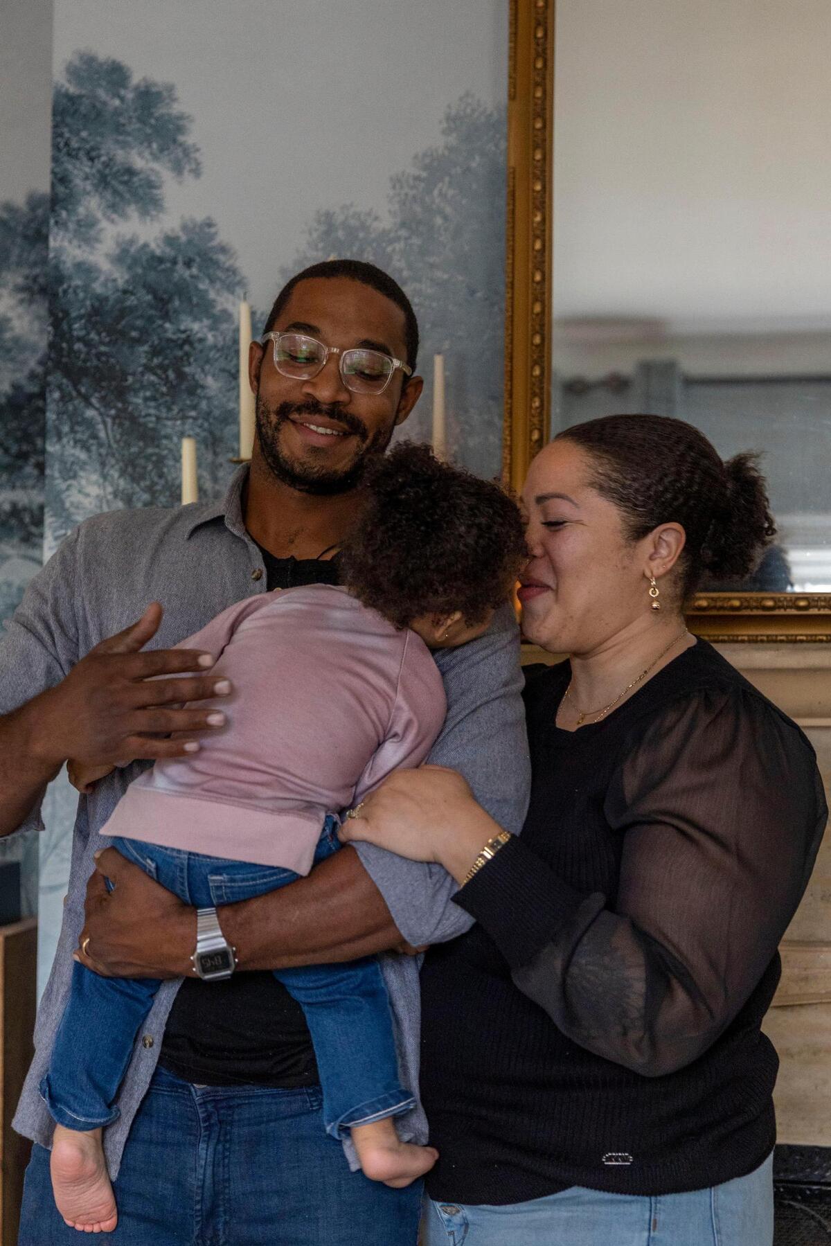 David Jones and partner Alea Lovely hold their 17-month-old daughter at their south Kansas City home. They met in summer 2020, when Lovely reached out to him on Bumble to ask how he was doing following the murder of George Floyd.