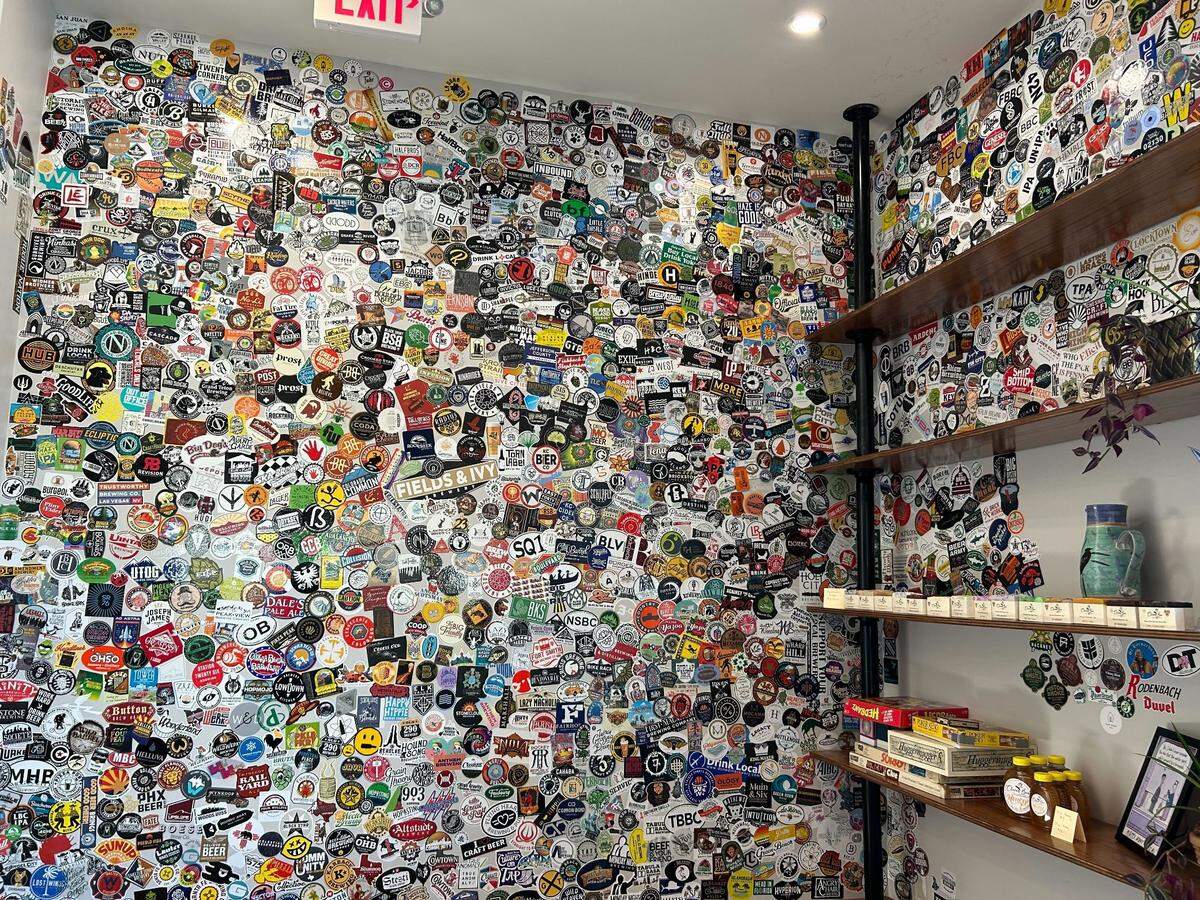Britton’s beer sticker wall features a shelf of games and products from local artisans.