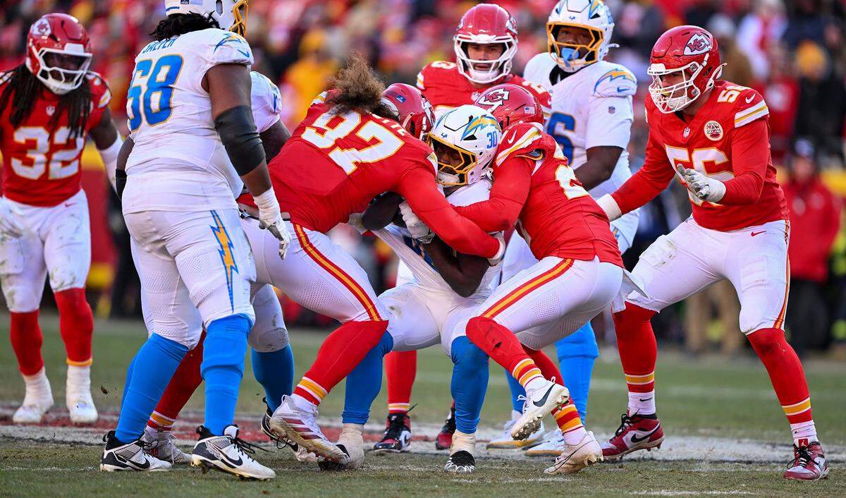 Kansas City Chiefs defensive end Ashton Gillotte (97) tackles Los Angeles Chargers running back Kimani Vidal (30) in the third quarter against the LA Chargers at GEHA Field at Arrowhead Stadium on Sunday, Dec. 14, 2025.