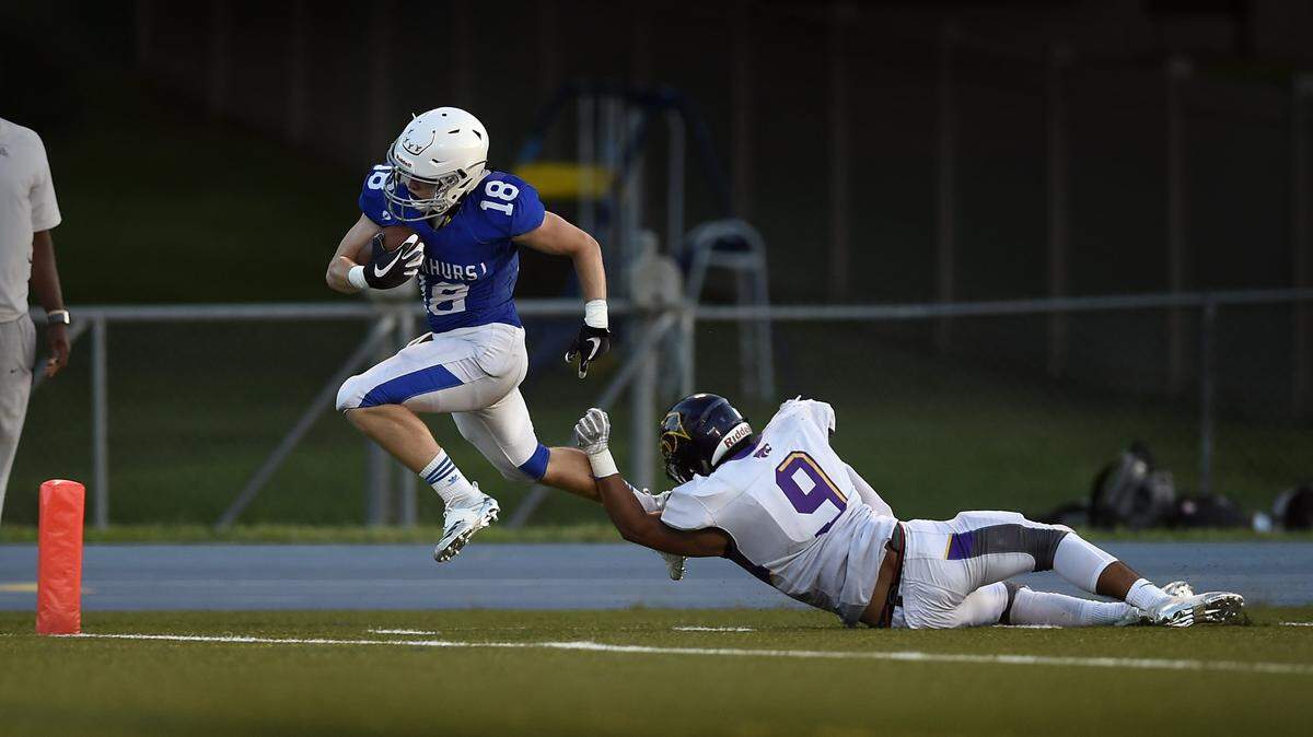 Joseph Coit of Rockhurst scored in the second quarter, despite the efforts of Ray-Ray Horton of Blue Springs on Friday at Rockhurst High School.