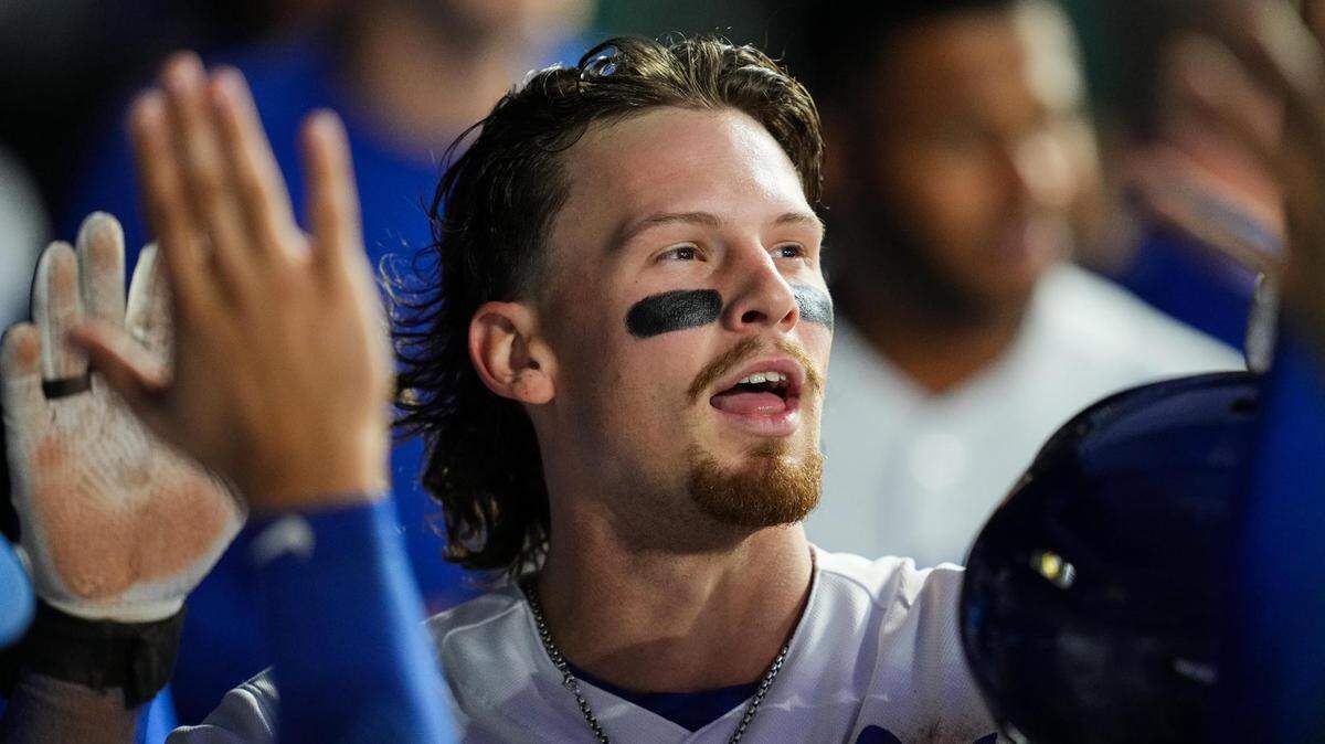 Kansas City Royals shortstop Bobby Witt Jr. (7) is congratulated by teammates after hitting an inside-the-park home run during the fifth inning against the Seattle Mariners at Kauffman Stadium on Aug. 14, 2023.