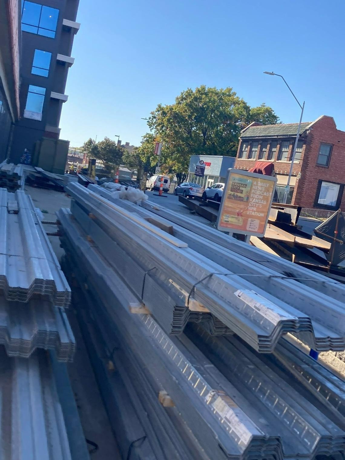 Steel beams sit outside the Katz on Main luxury apartment complex under construction at Main Street and Westport Road.